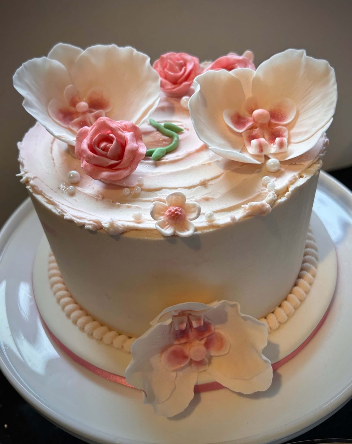 Orchid Edible Elegance Sugar-flower topped pink buttercream cake
