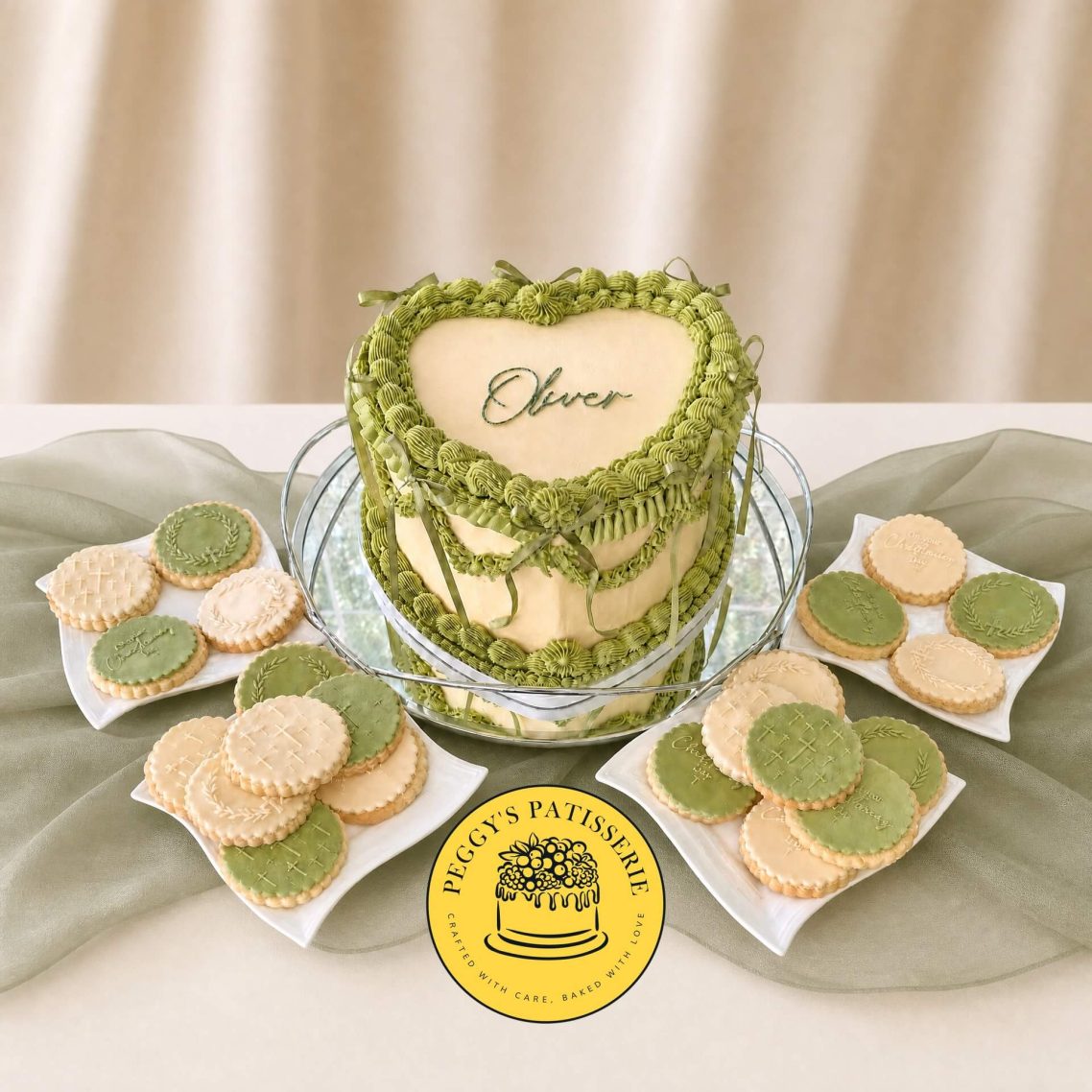 Sage Green & Cream Lambeth & Shortbread Biscuits Custom sage green & cream heart-shaped Lambeth style cake with "Oliver" lettering and matching iced biscuits by Peggy's Patisserie